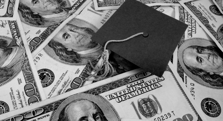 Graduation cap on a stack of money