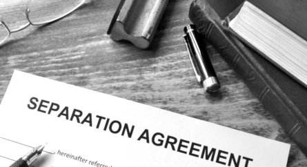 Separation Agreement on a desk with book, glasses and a pen