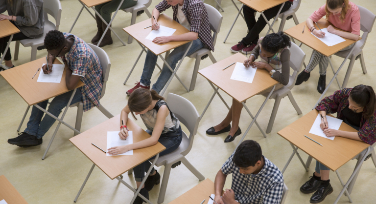 Elevated View Of Students Writing at Their Desks