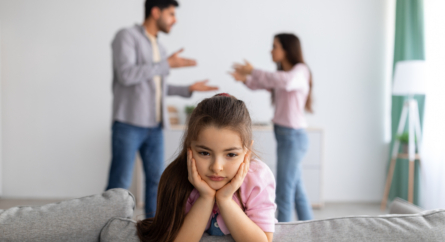 Managing Parental Conflict - Upset Girl with Angry Parents Fighting in Background