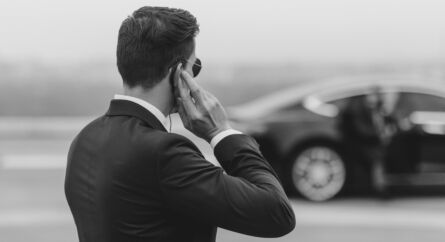 Body guard protecting a person getting out of a car