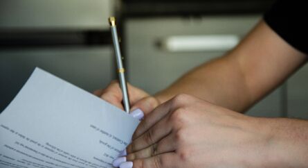 Female signing a document