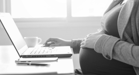 pregnant woman sitting at a computer