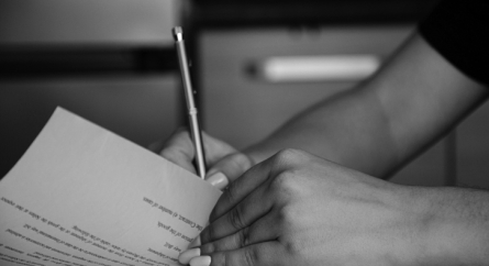 Young female signing legal documents